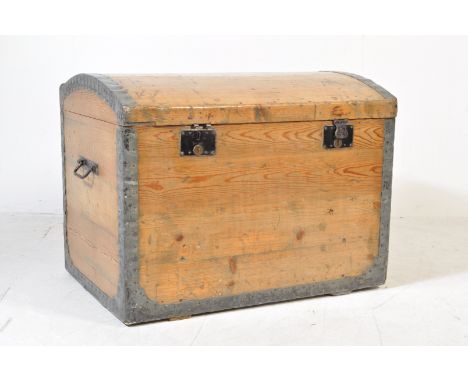 A 19th century Victorian pine dome top trunk having iron strapwork to the corners, carry handles to the side. The chest has a