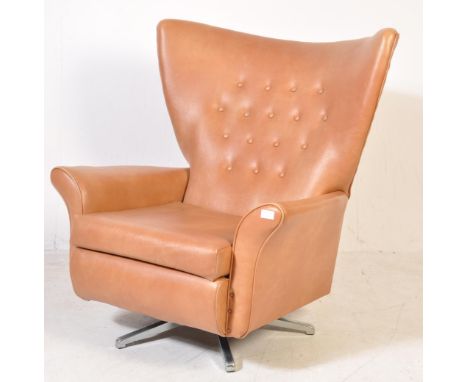 A vintage retro mid 20th century Danish inspired wingback swivel chair / armchair / easy chair. The chair having brown leathe