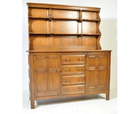 A mid century Ercol beech and elm wood dresser. Raised on stile legs with the base comprising of&nbsp; a series of drawers an
