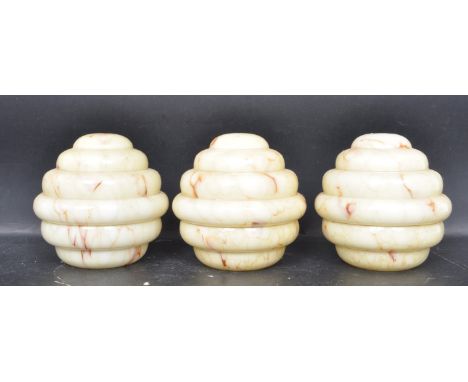 A collection of three retro vintage mid 20th century circa 1950s beehive mottled glass light shades in yellow and red.&nbsp;