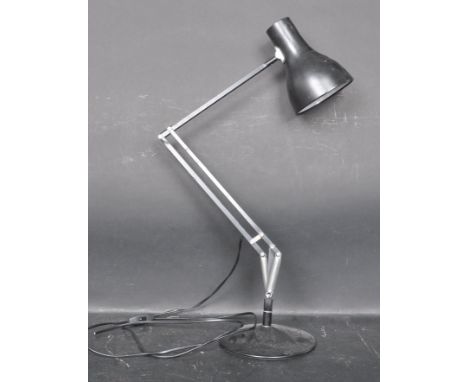 A retro style Herbert Terry Anglepoise lamp having a conical shade, three arm support raised on a circular support finished i