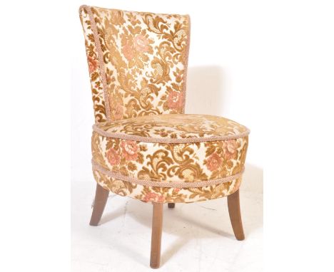 An early 20th circa 1930s century cocktail / boudoir chair having raised floral upholstery over a circular seat raised on sab