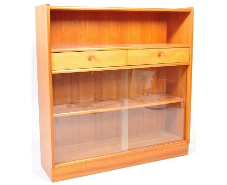 A mid century teak wood bookcase / display cabinet combination. Raised on a plinth base with glass sliding door bookcase with