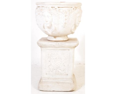 A contemporary reconstituted stone planter in white having classical motifs to the the bowl and pedestal base. Measures 70cm.