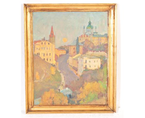 A vintage mid 20th century oil on canvas painting of a hillside village scene set within a green vinyl frame. Signed to the v