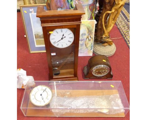A perspex cased droptrunk wall clock, having twin winding holes for an 8-day movement, with pendulum and two weights, h.77cm;