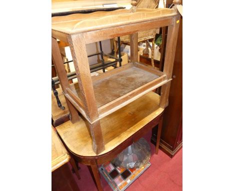 An early 19th century mahogany and faded rosewood D-end foldover card table; together with a 1930s relief carved oak two-tier