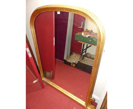 A contemporary mounded gilt framed arched over mantel mirror in the Victorian taste, 138.5 x 135cm