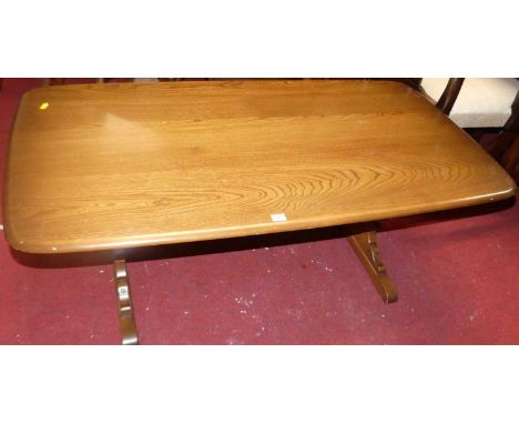 An Ercol mid-elm round cornered coffee table, length 127cm 