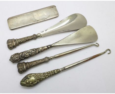 A silver mounted and cased comb, a matching silver handled shoe horn and button hook, one other silver handled shoe horn and 