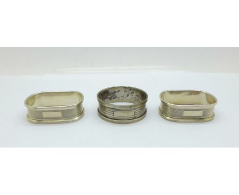 A pair of silver napkin rings and one other silver napkin ring, 31.1g 