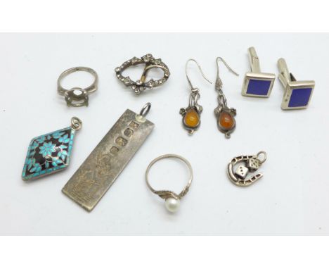 A silver and paste buckle, marked 900, a silver ingot pendant, personalised, an enamelled pendant, etc., one ring lacking sto