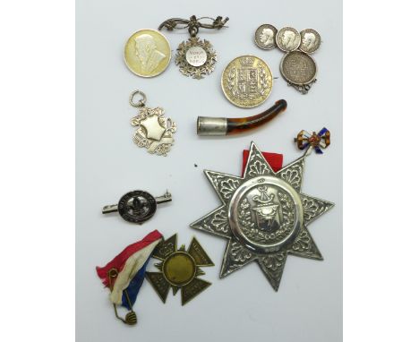 A large hallmarked silver Ancient Order of Foresters sash medal, two silver fob medals, three silver coin brooches, a Victori