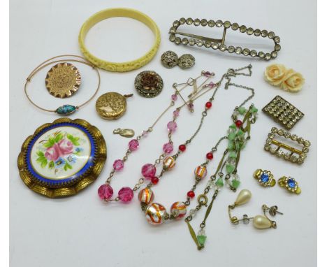 A collection of vintage jewellery including a porcelain brooch, three necklaces and two buckles 