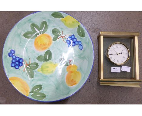 A heavy brass and glass mantel clock and a large bowl 