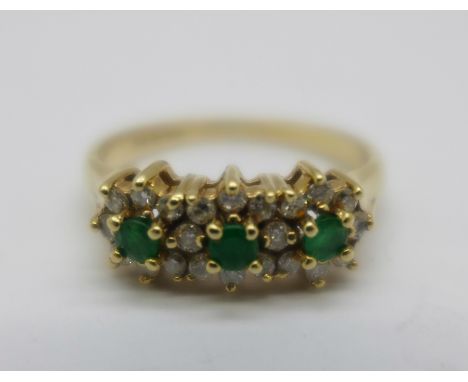 A 9ct gold, emerald and diamond triple cluster ring, 2.5g, M 