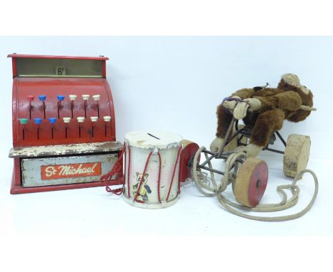 A Steiff Monkey on Wheels, a St. Michael toy till and a drum money box 