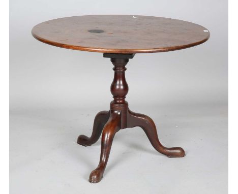 A George III mahogany circular tip-top supper table with a birdcage mount and substantial tripod base, height 72cm, diameter 