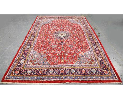 A Sarough carpet, Central Persia, late 20th century, the red field with a flowerhead medallion, within a blue scrolling vine 