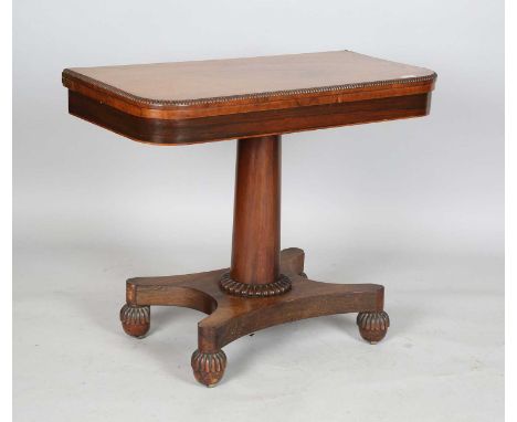 A Regency rosewood fold-over card table, the quatrefoil base on reeded cup feet, height 74cm, width 92cm, depth 45cm.