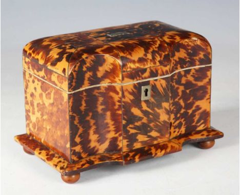 An early Victorian tortoiseshell tea caddy with inlaid metal stringing and ivory-trimmed interior, on turned vegetable ivory 