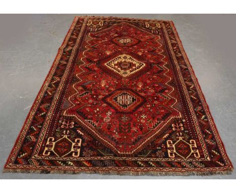A Ghashghai carpet, South-west Persia, late 20th century, the red field with three stepped medallions, within a charcoal serr