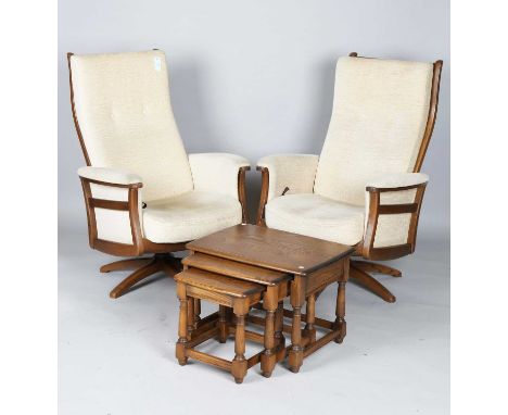 An Ercol 'Gina' three-piece suite, comprising a pair of reclining armchairs, height 114cm, width 75cm, and a settee, height 9
