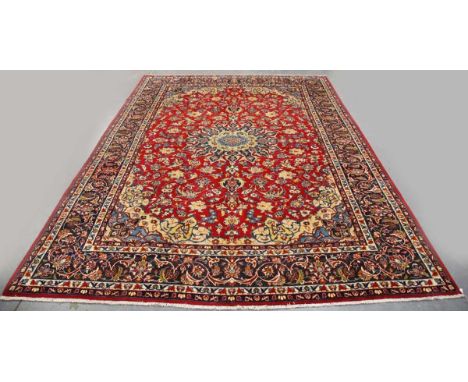 An Esfahan carpet, Central Persia, late 20th century, the red field with a shaped flowerhead medallion, within a shaded blue 