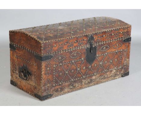 A 20th century brown leather and brass studded dome-topped trunk, height 47cm, width 90cm, depth 43cm.