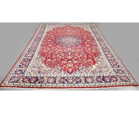 An Esfahan carpet, Central Persia, late 20th century, the red field with a flowerhead medallion, within a blue palmette and f