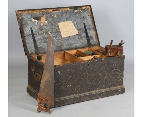 A Victorian pine carpenter's trunk, containing a collection of woodworking tools, including a sash plane, saws and chisels.
