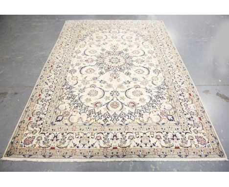 A Nain carpet, Central Persia, late 20th century, the ivory field with a flowerhead medallion, within a complimentary border,