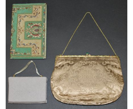 An early 20th Century silk evening bag with enamelled decorated gilt metal clasp, an early 20th Century embroidered purse, an