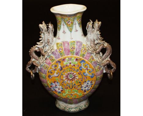 A Chinese famille-rose decorated moon vase with ornate relief work dragon handles, bears pseudo Qianlong seal mark, 32.5 cm h