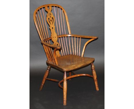 An early 19th Century Thames Valley yew wood and elm stick back Windsor type elbow chair with unusual fretwork carved back sp