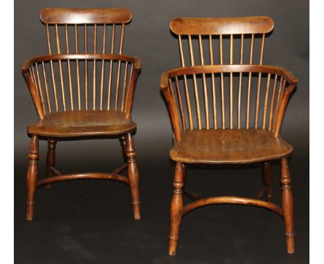 A pair of early 19th Century Thames Valley yew wood and elm bar and stick back elbow chairs, the shaped seats on baluster tur