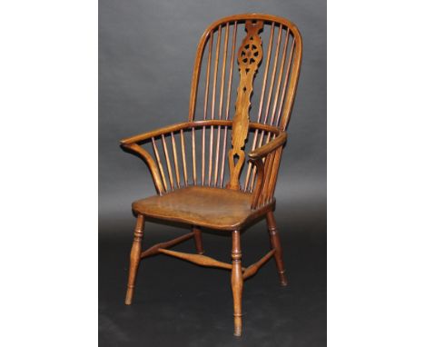 An early 19th Century Thames Valley beech and elm wheel and stick back Windsor type elbow chair, the shaped seat on turned an