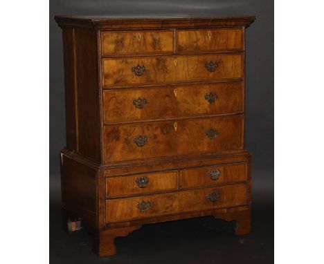 An early 18th Century oak and walnut chest on chest, the upper section with plain top over two short feather banded and three