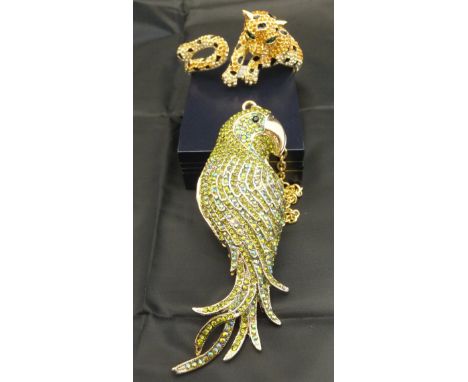 Two pieces of Butler & Wilson costume jewellery, a pendant in the form of a parrot and a bangle in the form of a leopard, bot