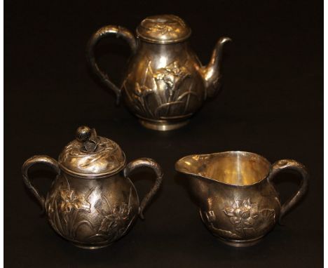A late 19th Century Japanese sterling silver hollow ware three piece tea set comprising teapot, sugar basin and milk jug with