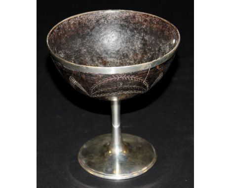 A Victorian silver mounted coconut cup, the shell engraved with various sailboats, raised on a plain stem base to circular fo