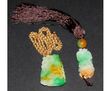 Two carved jade pendants, one as a graduated section of bamboo with a creature crawling up it, together with another in the f