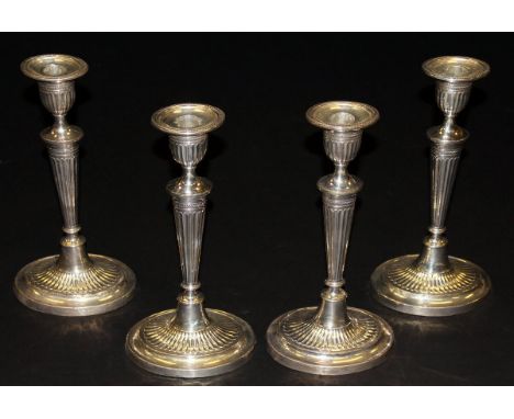 A set of four Edwardian silver sheathed candlesticks in the Adam manner (by Fordham & Faulkner, Sheffield, 1909), 29 cm high 