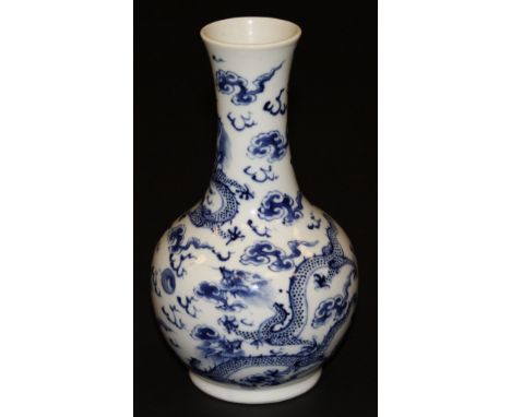 A Chinese blue and white gourd shaped porcelain vase with blue and white decoration of five five-toed dragons amongst clouds,