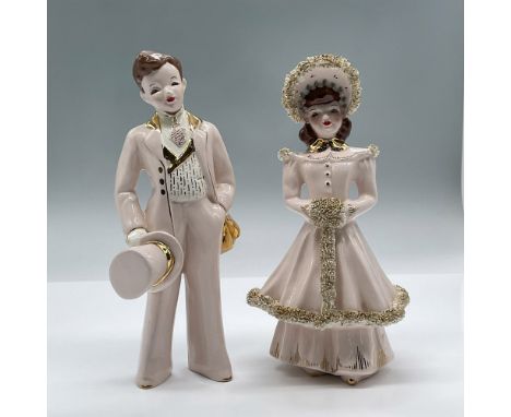 A pair of figurines in formal attire, wearing a soft pink color with gold gilded accents. Largest measures 4"L x 3.75"W x 7.5