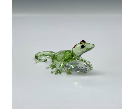 Limited edition event piece made from green crystal, with black eyes, and red stones on the top of his head holding a clear c