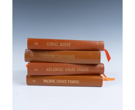 A set of 4 collector's Lifetime edition bound field guides in light brown genuine leather covers with orange bookmark ribbons