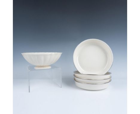 An exquisite cream-colored tableware set including four soup bowls embellished with a platinum trim and a fluted flower-shape