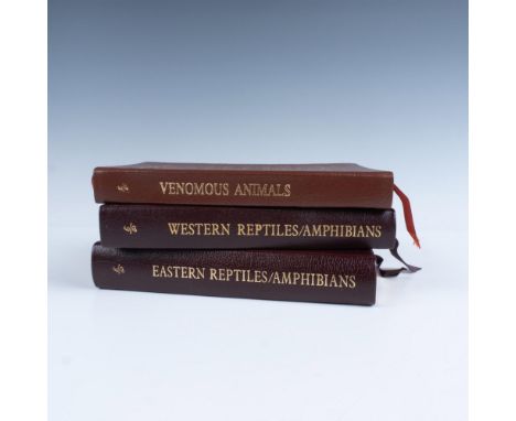 A set of 3 collector's Lifetime edition bound field guides in dark brown genuine leather covers with dark purple and brown bo