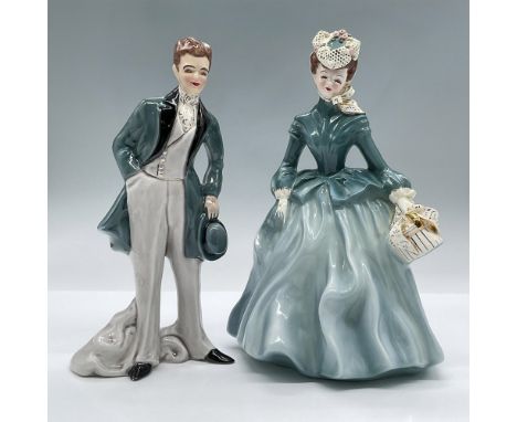 This pair of figurines are fashioned in turquoise colored formal attire with gilded gold details. Largest measures 6"L x 5.5"